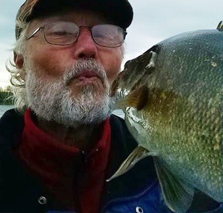 Milwaukee Slim kissing a bass