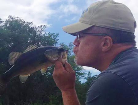 Scott kissing a bass